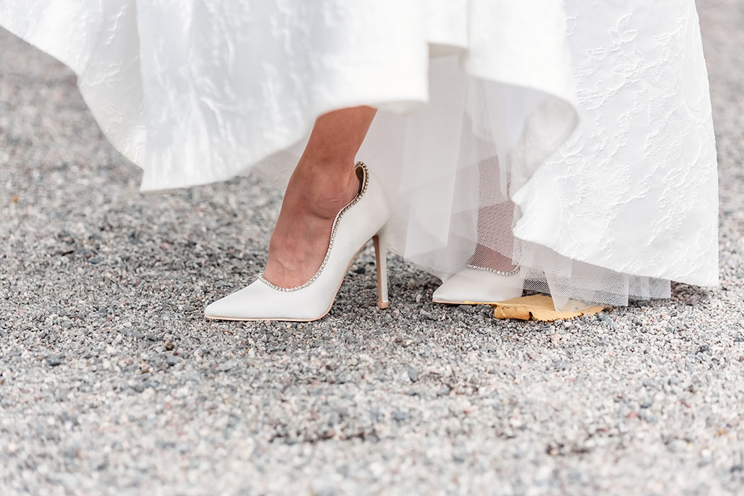 Brudens vackra högklackade vita skor.
